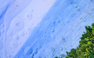 Oil bubbles in water glass, background