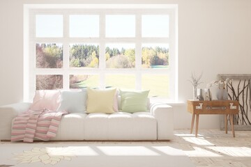 White stylish minimalist room with sofa and autumn landscape in window. Scandinavian interior design. 3D illustration