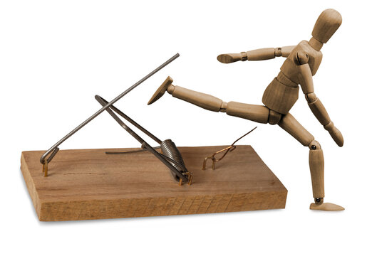 isolated image of a mousetrap and stylized wooden man