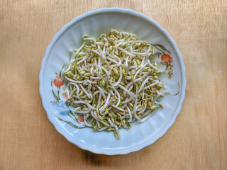 Raw bean sprouts in the bowl lay flat