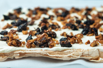 Prune and nut filler spread on white whipped sweat cream.