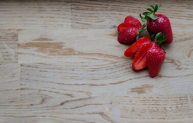 Ripe strawberries on wooden background with copy space