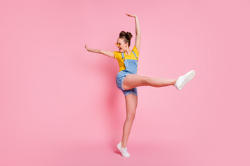 Full length body size view of her she nice attractive pretty carefree slim fit sporty cheerful cheery brown-haired girl jumping dancing having fun pirouette isolated on pink pastel color background © deagreez