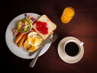 American Breakfast in a White Plate with a Knife and Fork