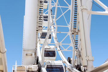 White metal Ferris wheel attraction mechanism engine, gears and cables. Machinery concept close-up no people.