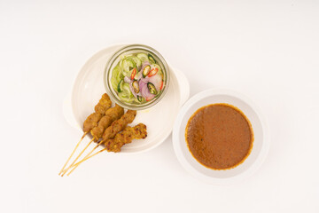 Pork satay - Grilled pork served with peanut sauce or sweet and sour sauce - Asian food style on white background.