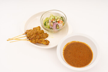 Pork satay - Grilled pork served with peanut sauce or sweet and sour sauce - Asian food style on white background.