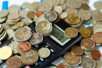Top view of papers, pen, calculator, coins and glasses on table, European Currency - Banknotes and Coins