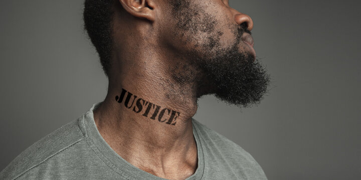 Close up portrait black man tired of racial discrimination has tattooed slogan justice on his neck. Concept of human rights, equality, justice, problem of violence and racism, discrimination. Flyer.