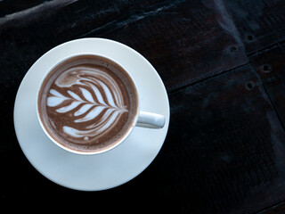 Leaf Coffee on The White Plate on The Dark Brown