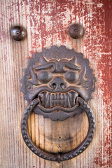 Door holder detail on red wooden door guardian protector at Bulguksa buddhist temple close to the city of Gyeongju, South Korea, Asia