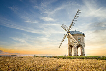 Plakat windmill in the countryside sunset