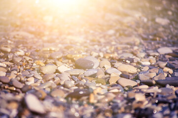 Sea pebble gravel beach. View from the top. Selective focus, toned colores.