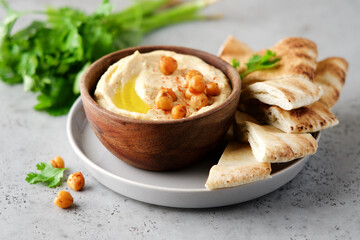 Hummus plate with pita bread. Middle Eastern traditional appetiser. Authentic arab cuisine