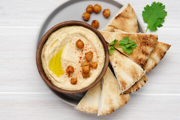 Hummus plate with pita bread. Middle Eastern traditional appetiser. Authentic arab cuisine