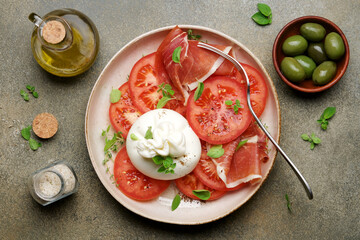 Buratta salad with tomatoes. Traditional Mediterranean appetizer. Italian Cuisine