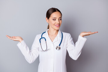 Photo of attractive family doc professional hold two open palms novelty products advising good...