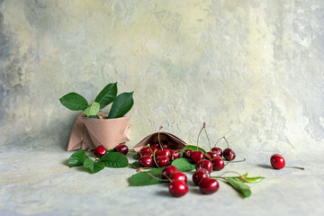 Origami paper cups with cherries. Eco-friendly food packaging, on an abstract beautiful background with a copy space. The preservation of nature and the concept of recycling. selective focus.