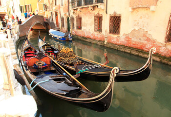 Fototapeta na wymiar Gondolas in a small canal in Venice, Italy.