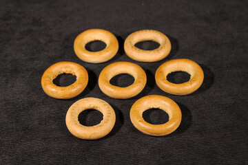 Freshly baked dough bagel on a black background.