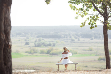 Attractive young woman outdoors on summer background. Vacation and rest concept.