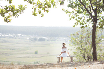 Attractive young woman outdoors on summer background. Vacation and rest concept.