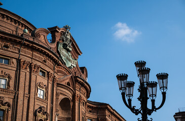 Fototapeta na wymiar Turin, Piedmont, Italy. May 2020. Palazzo Carignano, in the square of the same name. An imposing Baroque palace, it has a red brick facade characterized by wavy shapes.
