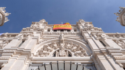 MADRID, SPAIN ,JUNE 05, 2020 :  FACADE OF CIBELES TELECOMMUNICATION PALACE ,WITH A FLAG OF SPAIN IN THANKS TO THE DOCTORS, IN THE COVID-19 PANDEMIC IN 2020