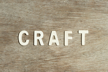 Alphabet letter in word craft on wood background