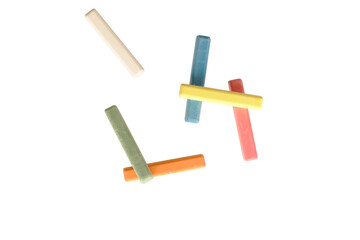 Colorful chalk clustered together lying flat on a blank white isolated background