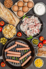 Sausages in pan. Bacon cheese, vegetables, cookies cereal yogurt: ingredients for  continental breakfast