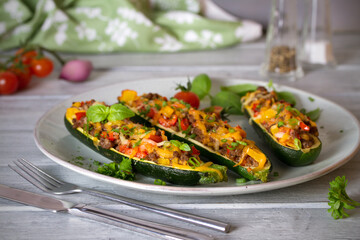 Zucchini stuffed with meat, vegetables and cheese. Zucchini boats. Loaded zucchini. Horizontal image