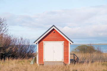Fototapeta na wymiar A neat minimalistic shed by the sea.
