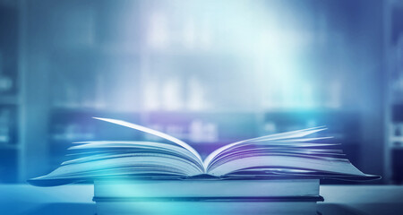 Stack of books in the library and blur bookshelf background