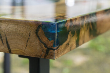 Beautiful wooden table made of elm slab with epoxy resin filling