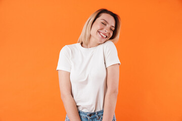 Image of joyful attractive woman laughing with eyes closed
