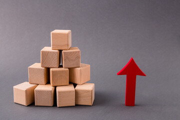 Photo of pile stack wooden cubes market supply sales growing rising raising red arrow pointing up income money progress profit isolated over dark pastel grey color background