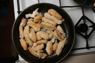Pieces of chicken fillet fried in a pan. Cooking Sliced ​​Chicken Fillet.
