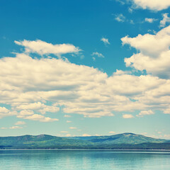 Naklejka na ściany i meble scenic mountain lake with sky and clouds. nature background.