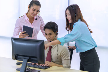 We pride ourselves in delivering quality customer services. Shot of a group of young call centre agents wearing headsets and working on their computers in an office.