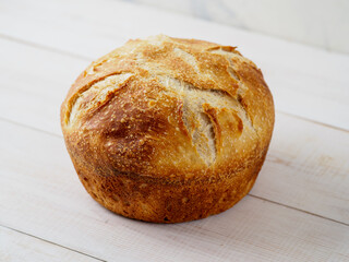 Loaf of bread on wooden background.