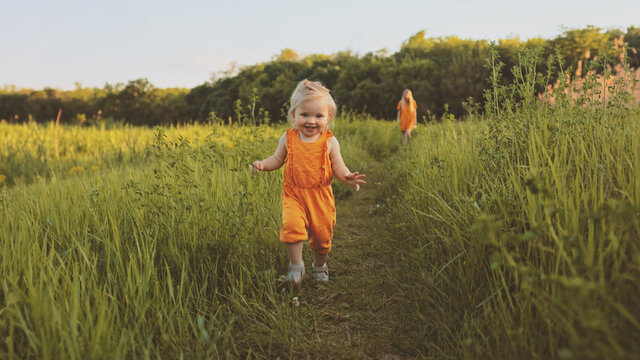 Toddler girl walking outdoor with mother family vacations child traveling eco tourism happy smiling emotions summer season nature