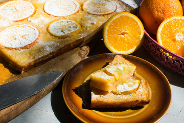 Homemade citrus tart with slices of lemon and oranges on top.