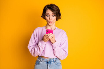 Portrait of astonished cute sweet teen girl use smartphone follow social network website impressed...