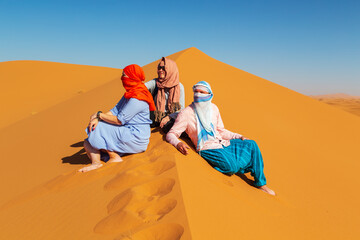 Fototapeta na wymiar Group of friends in the Sahara desert.