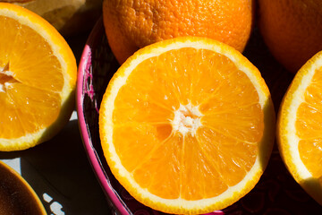 Freshly cut oranges on a pink tray. 