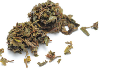 Loose black tea leaves used after brewing tea with it, isolated, white background