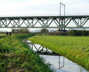 Fototapeta premium Detail of a railbridge and its reflection in a ditch 