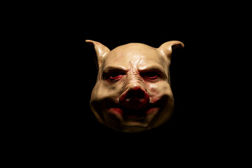 Scary pig mask isolated on black background. Bloody horror mask. Halloween concept.