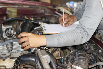 auto mechanic changing car engine